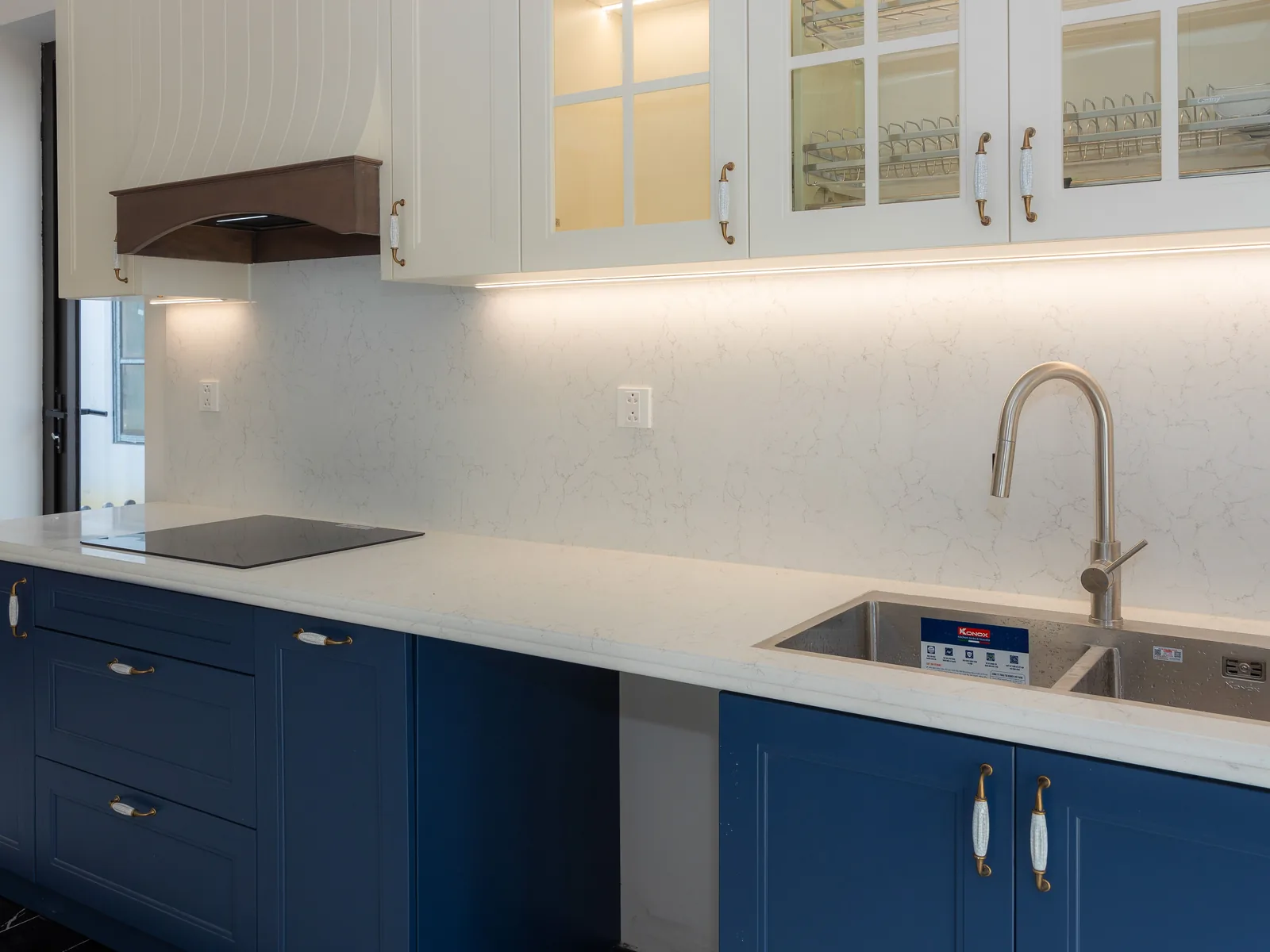 Navy blue kitchen cabinets with white quartz countertop