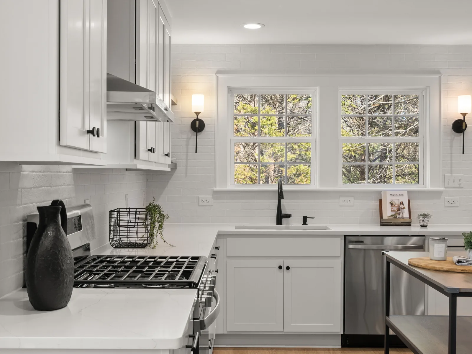 White kitchen with range hood sconces and new cabinets