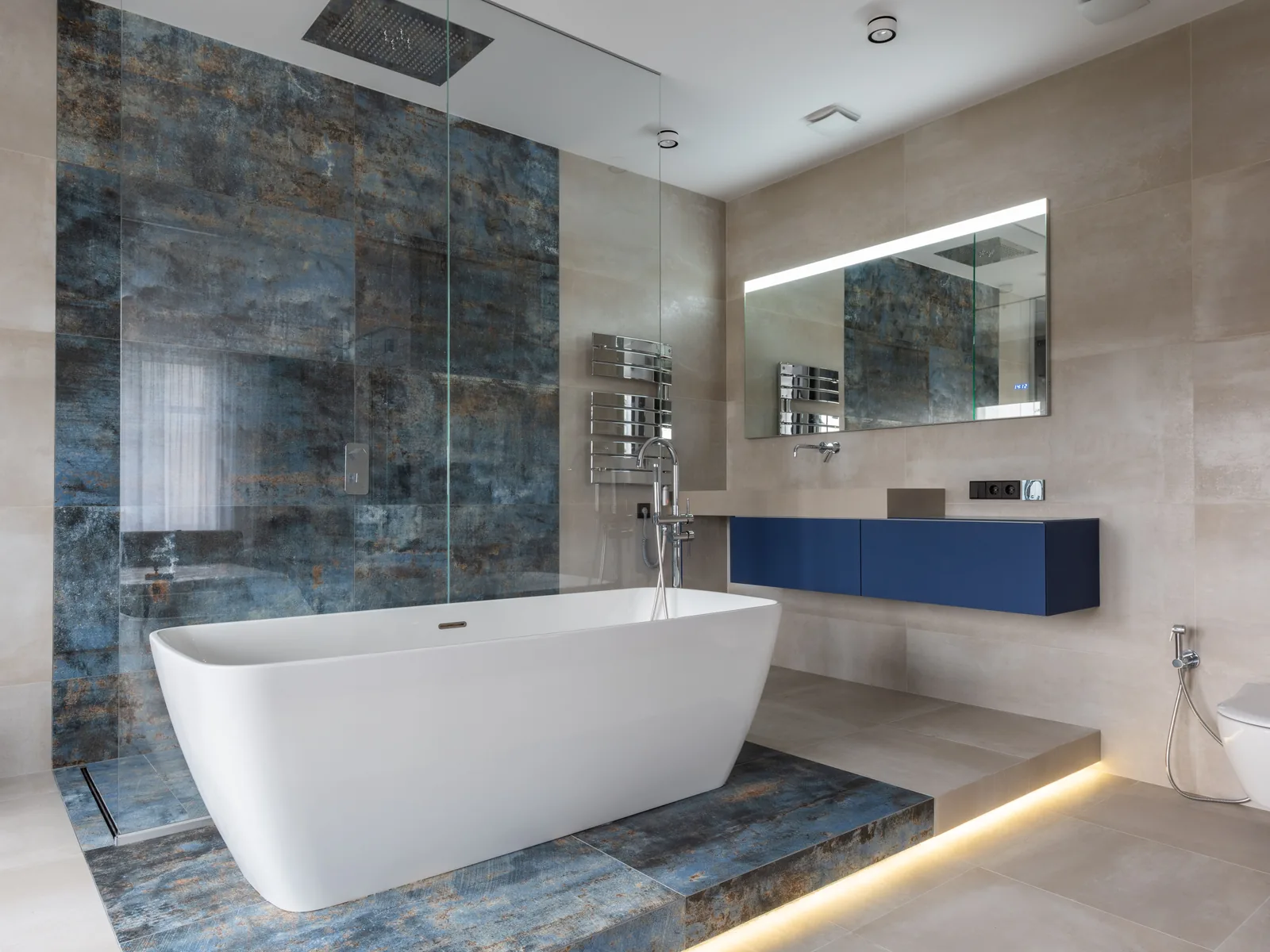 Modern bathroom with freestanding tub and blue feature wall